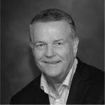 A black and white photo of a man in a suit.