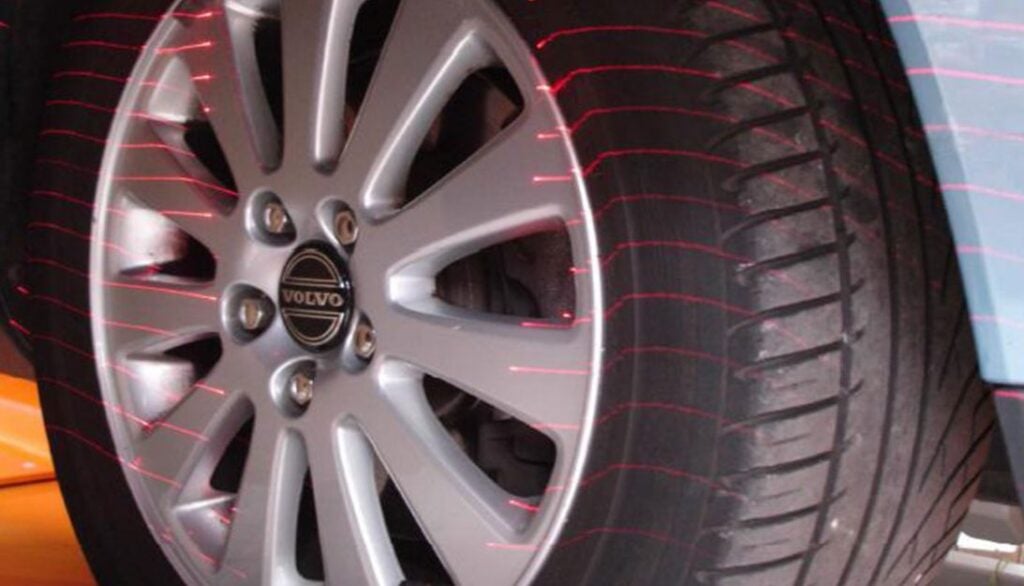 A close up of a car tire with a red light on it.