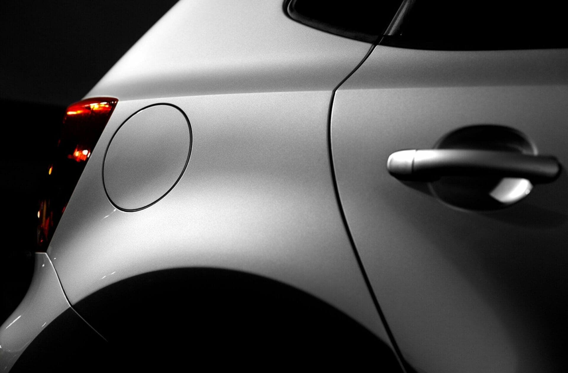 A black and white photo of a car door handle.