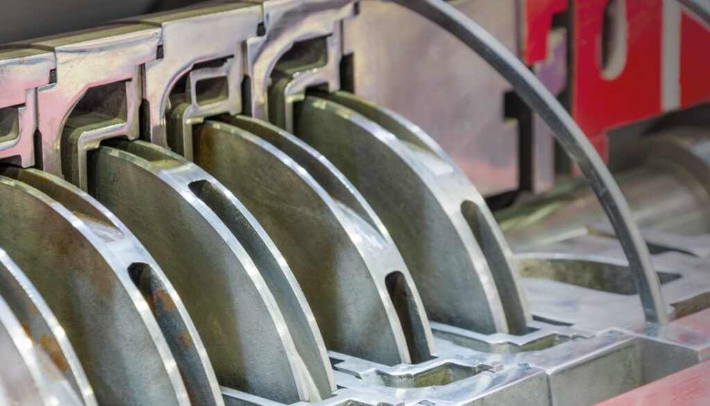 A close up of a machine that makes metal parts.