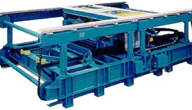 A blue machine that is used to make concrete blocks.