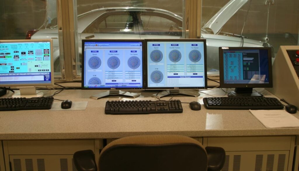 Four monitors on a desk.