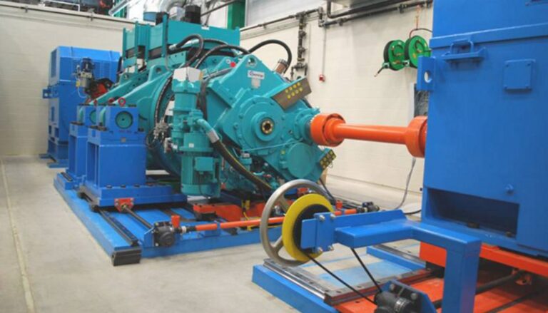 A blue and orange machine in a factory.
