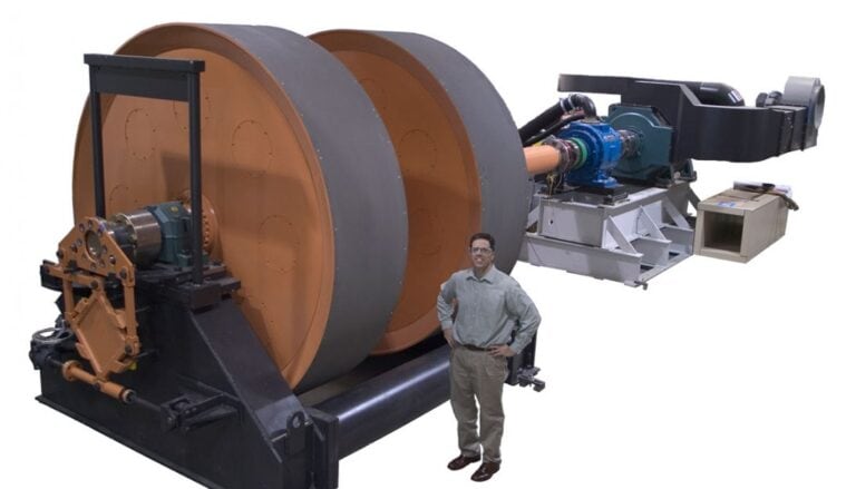 A man standing in front of a large machine.