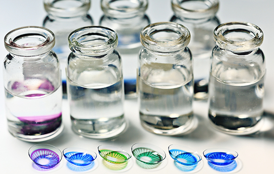 A group of bottles with different colored liquids in them.